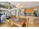 Open-concept dining area adjacent to living room with backyard view at 9158 Forest St, Firestone, CO 80504
