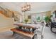 Elegant dining room with a long table, bench seating, and abundant natural light at 9158 Forest St, Firestone, CO 80504