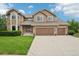 Charming two-story home with manicured lawn, three-car garage, and inviting stone accents at 9158 Forest St, Firestone, CO 80504