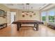 A spacious game room boasts a beautiful pool table and stylish lighting fixtures at 9158 Forest St, Firestone, CO 80504