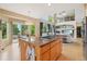 Open kitchen with central island cooktop and breakfast nook with backyard view at 9158 Forest St, Firestone, CO 80504