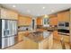 Bright kitchen features stainless steel appliances, granite countertops, kitchen island, and hardwood floors at 9158 Forest St, Firestone, CO 80504