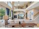 Spacious living room with soaring ceilings, fireplace, and abundant natural light at 9158 Forest St, Firestone, CO 80504