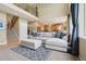 Open-concept living room featuring neutral decor, large windows, and staircase at 9158 Forest St, Firestone, CO 80504