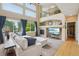 Bright living room featuring a fireplace, large windows, and comfortable seating at 9158 Forest St, Firestone, CO 80504