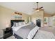 Main bedroom features neutral paint, ceiling fan, and ensuite bathroom at 9158 Forest St, Firestone, CO 80504
