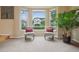 Cozy sitting area with two chairs, decorative pillows, large windows, and a view at 9158 Forest St, Firestone, CO 80504