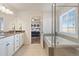 Elegant bathroom with double sinks, granite countertops, a soaking tub, and a glass-enclosed shower at 3008 Echo Park Dr, Castle Rock, CO 80104