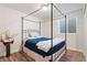 Bedroom with a four-poster bed, wood-look flooring, and a window with natural light at 3008 Echo Park Dr, Castle Rock, CO 80104