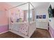 Whimsical pink bedroom with a canopy bed, cute decorations, and a stylish dresser at 3008 Echo Park Dr, Castle Rock, CO 80104