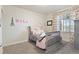 bedroom with pink accents, a crib-style bed, and cozy carpeting at 3008 Echo Park Dr, Castle Rock, CO 80104