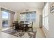 Bright dining area with a wooden table, stylish rug, and sliding door access to the outdoor space at 3008 Echo Park Dr, Castle Rock, CO 80104