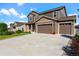 Charming exterior of home featuring a three-car garage, manicured lawn and inviting covered porch at 3008 Echo Park Dr, Castle Rock, CO 80104