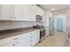 Modern kitchen with sleek stainless steel appliances, white cabinetry, and a stylish backsplash at 3008 Echo Park Dr, Castle Rock, CO 80104