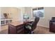 Cozy home office with a large wooden desk and ample natural light from the window at 3008 Echo Park Dr, Castle Rock, CO 80104