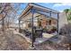 Backyard covered patio with lounge seating, patio furniture and outdoor lighting at 5370 W 74Th Ave, Arvada, CO 80003