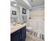 Bright bathroom featuring a walk-in tub, single sink vanity, and modern fixtures at 5370 W 74Th Ave, Arvada, CO 80003