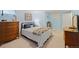 Bedroom features a cozy quilt, soft blue walls, and wood furnishings at 5370 W 74Th Ave, Arvada, CO 80003