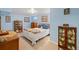 Cozy bedroom with light blue walls, multiple display cases, and a bright, multi-colored quilt at 5370 W 74Th Ave, Arvada, CO 80003