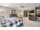 Inviting bedroom with a ceiling fan, fireplace, and a well-lit ensuite bathroom at 5370 W 74Th Ave, Arvada, CO 80003