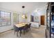 Bright dining room featuring modern lighting and a view to the front of the home at 5370 W 74Th Ave, Arvada, CO 80003