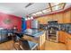 Bright kitchen boasting an island with seating, stainless steel appliances, and warm-toned cabinetry at 5370 W 74Th Ave, Arvada, CO 80003