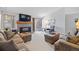 Comfortable living room with a fireplace, plush seating, and a sliding glass door providing natural light at 5370 W 74Th Ave, Arvada, CO 80003