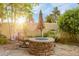 Cozy backyard featuring a stone fire pit and comfortable seating area for outdoor relaxation at 17995 Minglewood Trl, Monument, CO 80132