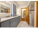 Spacious primary bathroom with tiled floor, double vanity, and walk-in shower at 17995 Minglewood Trl, Monument, CO 80132