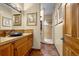 Charming bathroom with wooden cabinets, stone floors, blue bowl sink, and tiled walk-in shower at 17995 Minglewood Trl, Monument, CO 80132