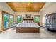 Inviting bedroom with wood-paneled ceiling and ensuite bathroom at 17995 Minglewood Trl, Monument, CO 80132