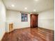 Cozy bedroom with hardwood floors and a built-in niche, plus a dark-wood armoire at 17995 Minglewood Trl, Monument, CO 80132