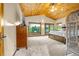 Bright, spacious bedroom with a wood ceiling, great views, and plenty of natural light at 17995 Minglewood Trl, Monument, CO 80132