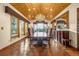 Formal dining room featuring a grand chandelier and large windows with picturesque views at 17995 Minglewood Trl, Monument, CO 80132