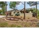 Stunning stucco home with a charming, landscaped front yard and mature pine trees at 17995 Minglewood Trl, Monument, CO 80132
