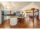 Open kitchen and dining area with white cabinets, island seating, and tile floors at 17995 Minglewood Trl, Monument, CO 80132