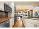 Open kitchen with stainless steel appliances, granite countertops, and a seamless flow to the dining area at 17995 Minglewood Trl, Monument, CO 80132