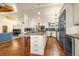 Spacious kitchen with white cabinets, stainless steel appliances and island with granite countertop at 17995 Minglewood Trl, Monument, CO 80132