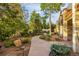 Beautifully landscaped pathway winding through lush greenery and mature trees at 17995 Minglewood Trl, Monument, CO 80132