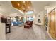 Expansive living room with vaulted wood ceilings, fireplace, and abundant natural light at 17995 Minglewood Trl, Monument, CO 80132