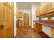 Mud room features custom wooden cabinets, utility sink, and a door to the backyard at 17995 Minglewood Trl, Monument, CO 80132