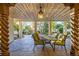 Charming covered patio with an elegant dining set and rustic architectural details at 17995 Minglewood Trl, Monument, CO 80132