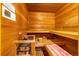 Relaxing sauna with wooden benches and paneling, as well as a traditional heater and bucket at 17995 Minglewood Trl, Monument, CO 80132