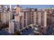 Aerial view of a multi-story apartment building with ample parking and city skyline in the background at 601 W 11Th Ave # 910, Denver, CO 80204
