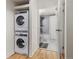 Bathroom featuring a stackable washer and dryer adjacent to a marble walk-in shower at 601 W 11Th Ave # 910, Denver, CO 80204