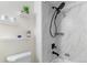 Bathroom featuring a tiled walk-in shower and decorative shelving above the toilet at 601 W 11Th Ave # 910, Denver, CO 80204