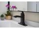 Close-up of modern black bathroom fixtures paired with white countertop and modern decor at 601 W 11Th Ave # 910, Denver, CO 80204