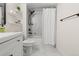 Modern bathroom featuring a white vanity, black fixtures, and a shower over a tub with marble-look tile at 601 W 11Th Ave # 910, Denver, CO 80204