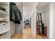 Hallway with organized closet space on the left and ski equipment stored on the right at 601 W 11Th Ave # 910, Denver, CO 80204