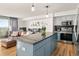 Modern kitchen featuring granite countertops, stainless steel appliances, and light blue cabinetry at 601 W 11Th Ave # 910, Denver, CO 80204